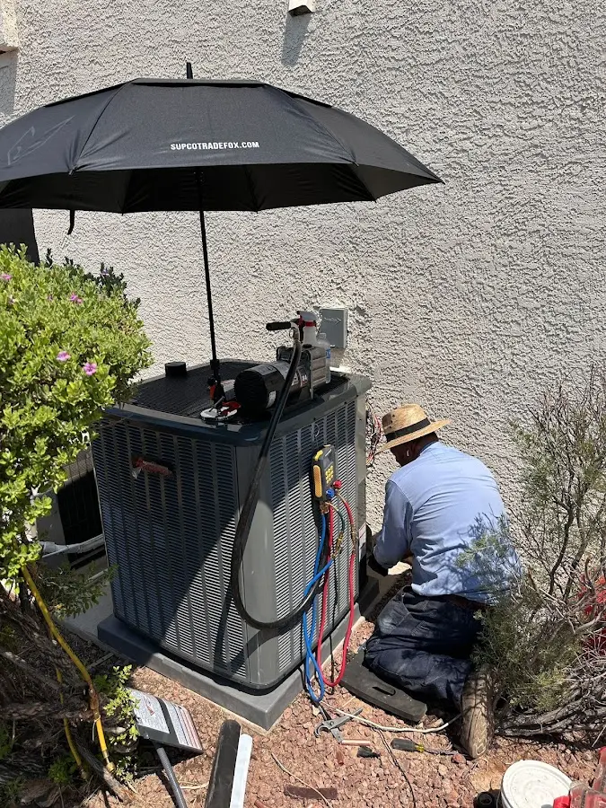 HVAC technician performing outdoor AC maintenance in Oak Brook